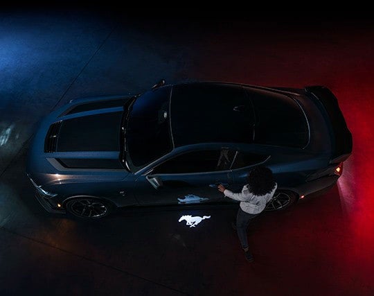 2024 Ford Mustang® Dark Horse™ model with a driver approaching the vehicle | Carriage Ford Inc in Clarksville IN
