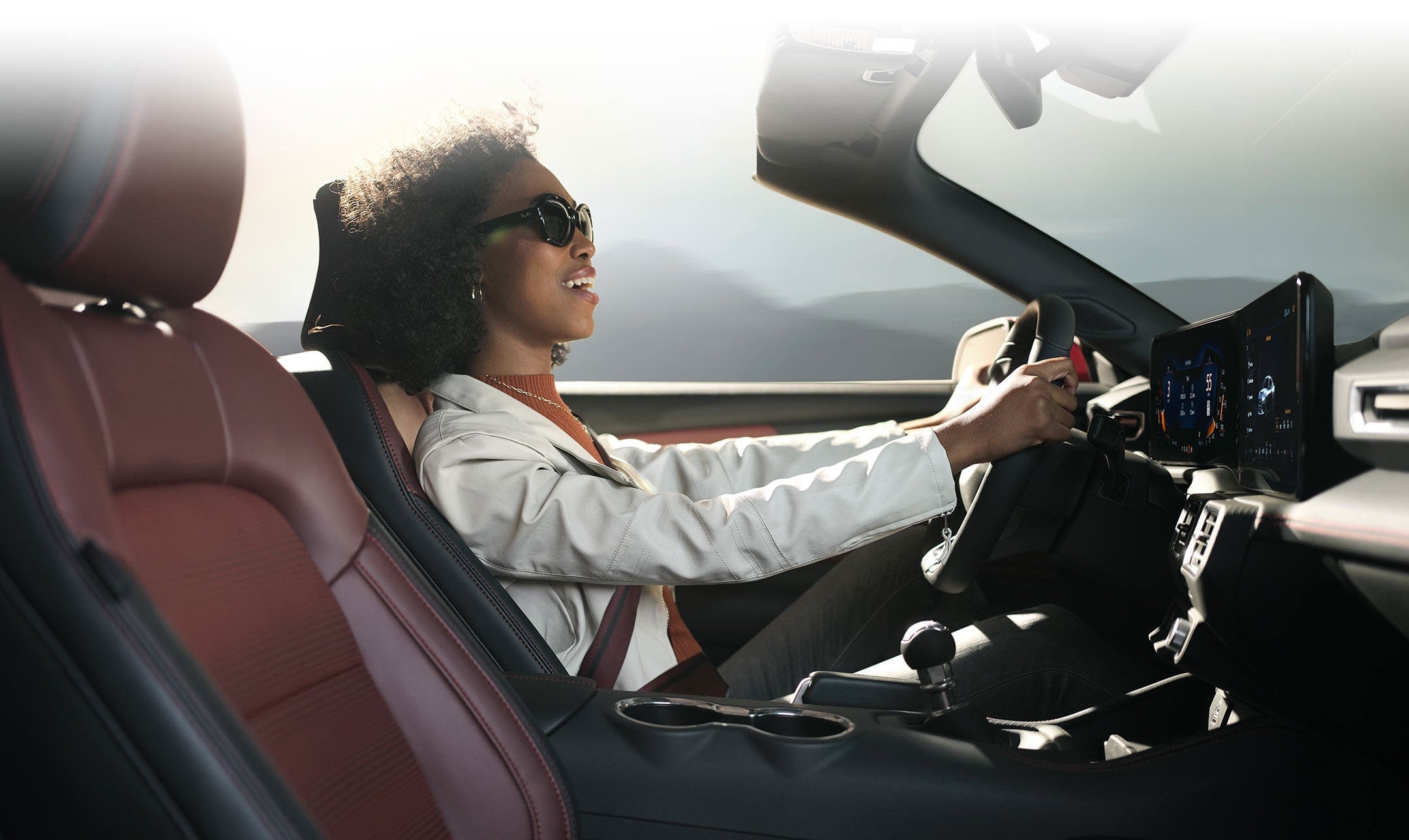 Person sitting in the driver’s seat of a 2024 Ford Mustang® convertible | Carriage Ford Inc in Clarksville IN