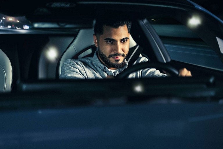 Person sitting in the driver’s seat of a parked 2024 Ford Mustang® coupe | Carriage Ford Inc in Clarksville IN